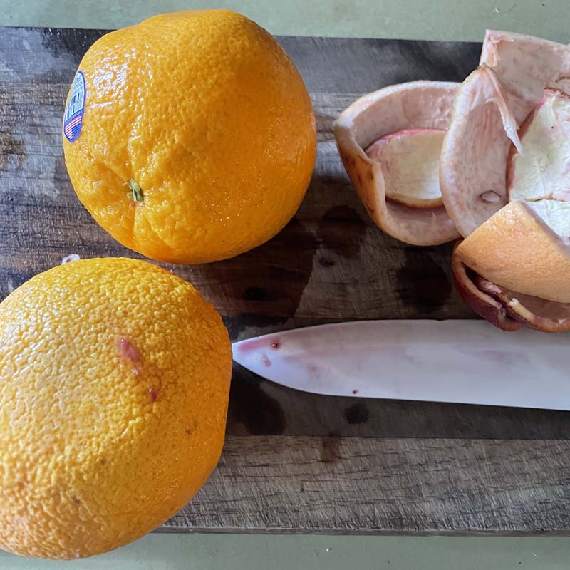 Oranges on cutting board with knife